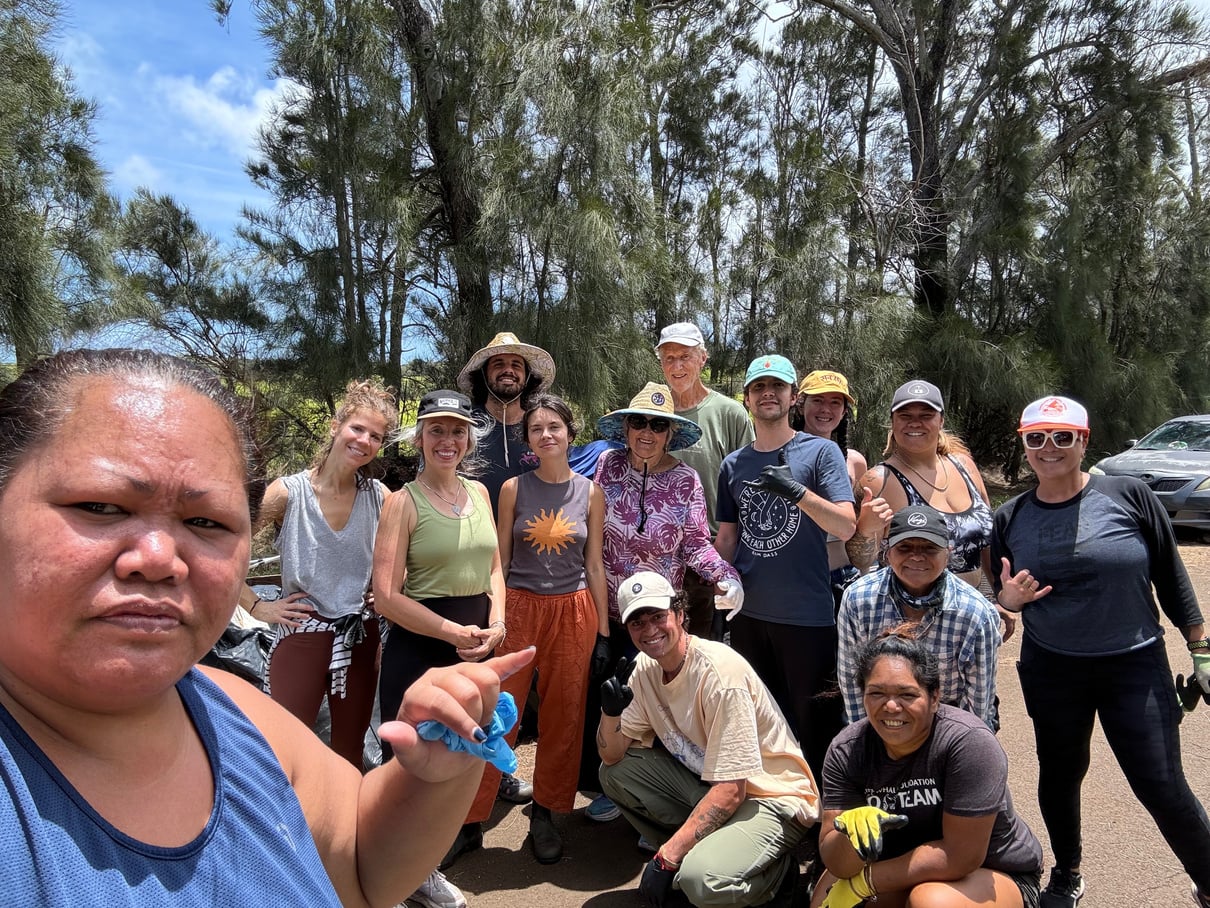 A group of volunteers posing together during the May 2 Holomua Road cleanup