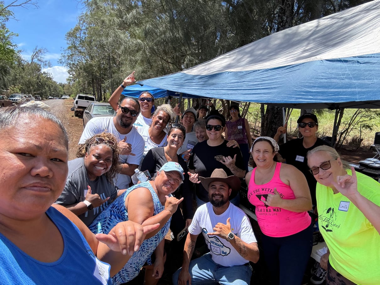 Volunteers gathered together during a Holomua Road community cleanup