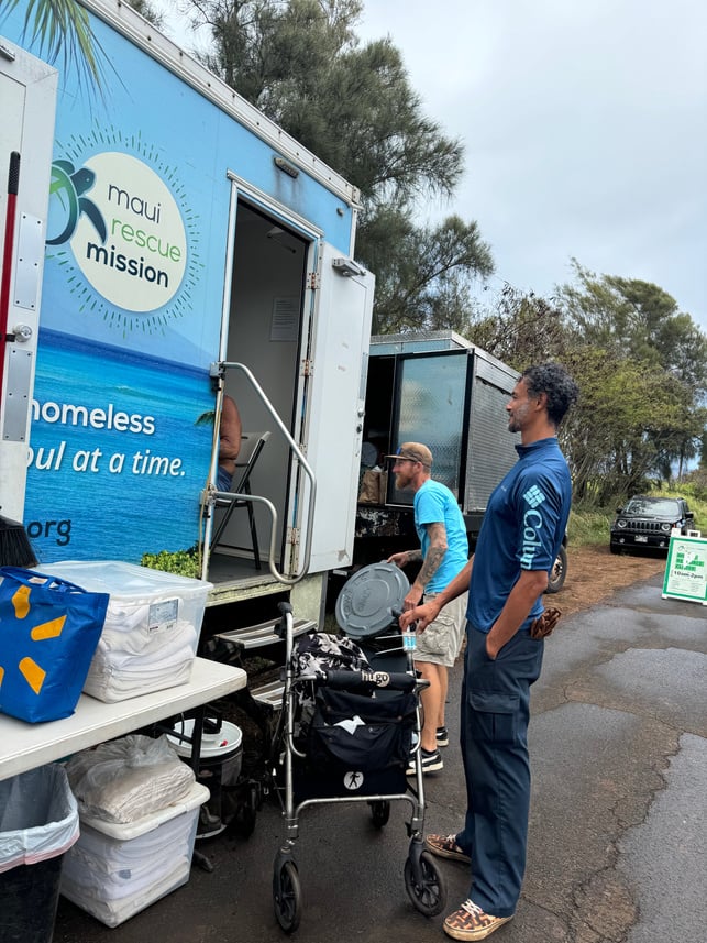 People working beside the Maui Rescue Mission mobile outreach vehicle