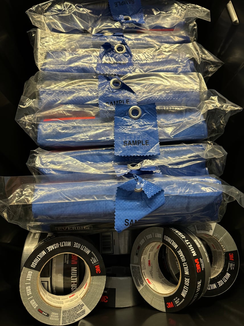Packaged tarps and rolls of heavy-duty repair tape