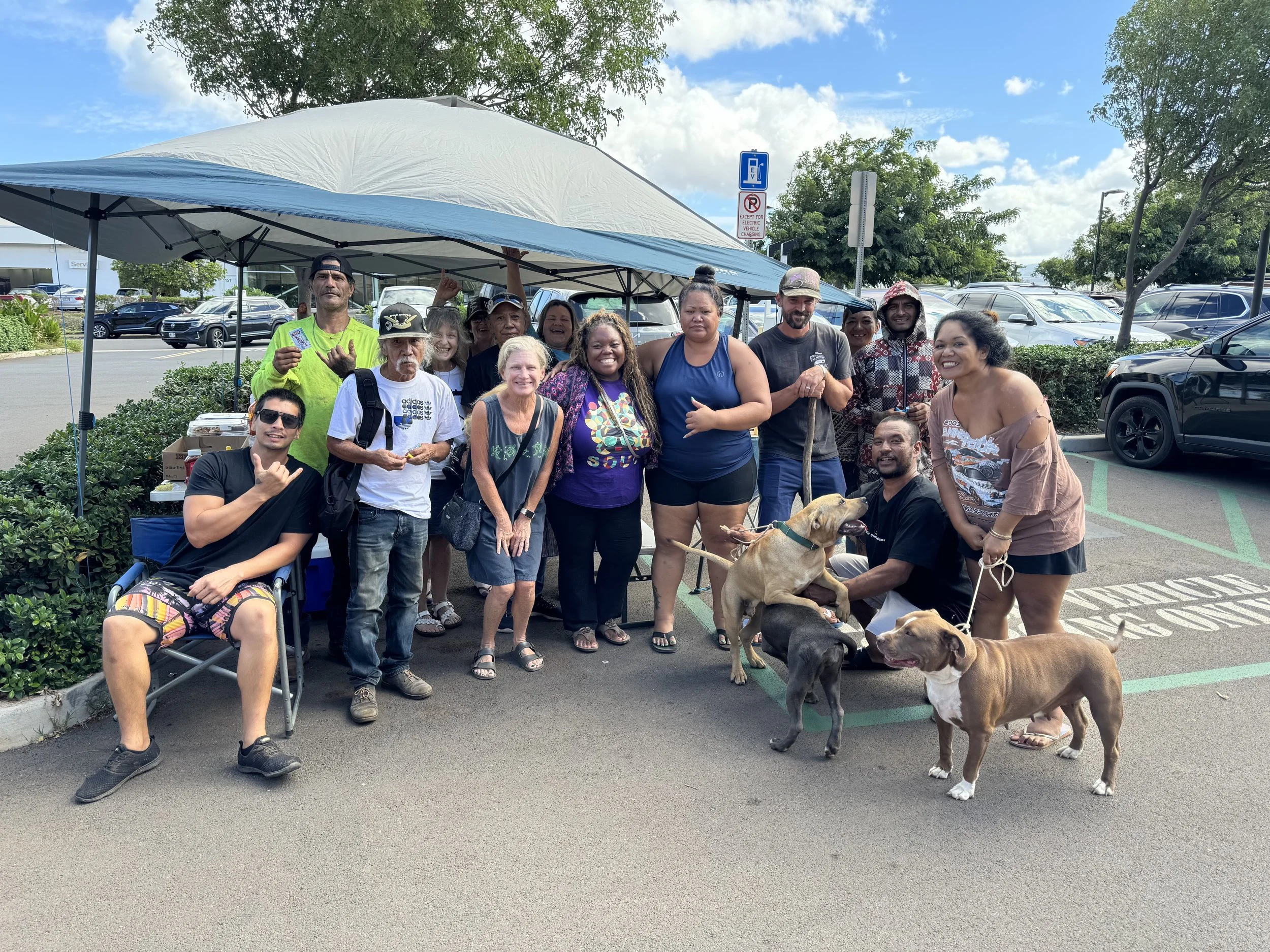 Holomua Outreach community members gathered together at an outdoor resource event